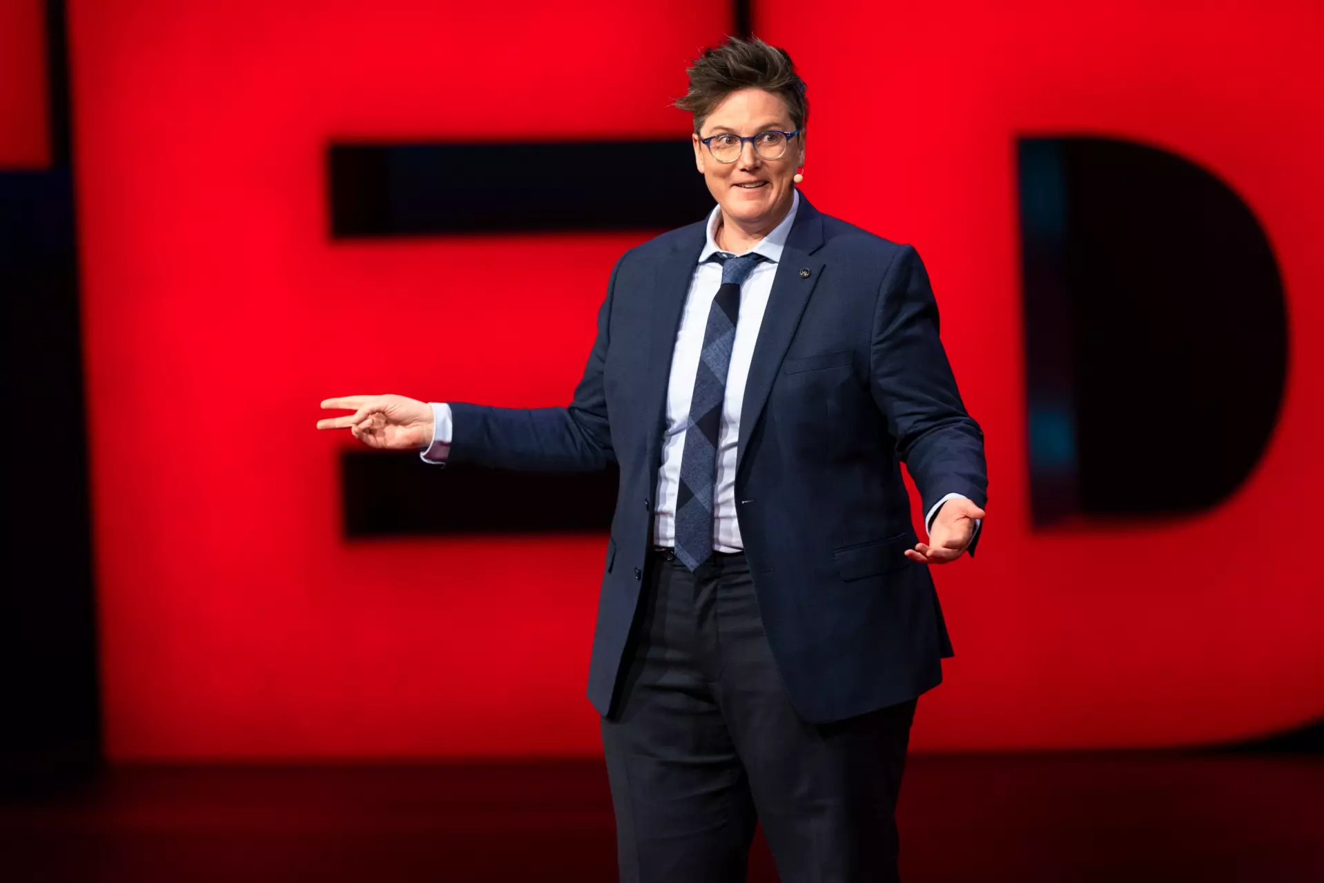 Hannah Gadsby doing a talk or comedy performance at TED