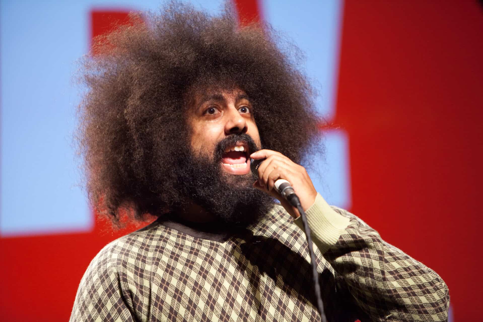Reggie Watts performs comedy on stage